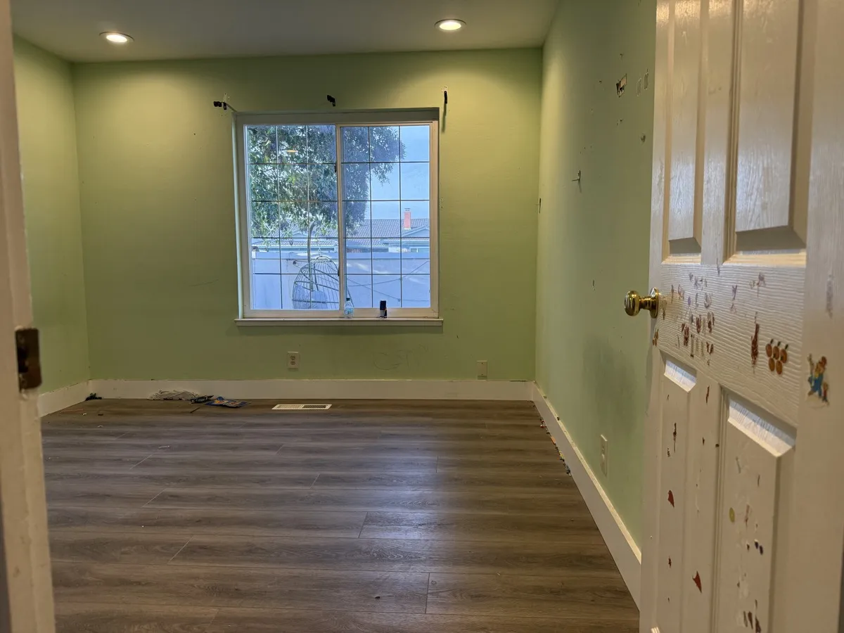 Green room with sticker-covered door